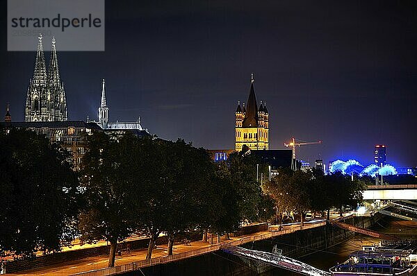 View of Cologne Dom Cathedral and Great St Martin Church at night from the chocolate museum