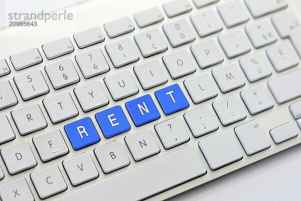 RENT writing on white keyboard