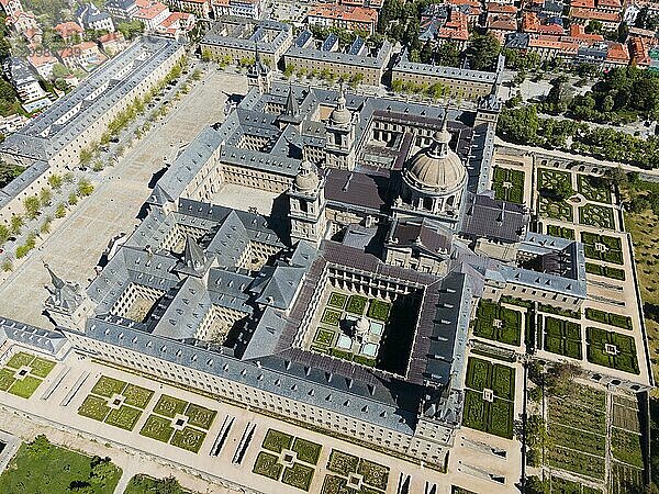 Aerial view of a large historic monastery with many courtyards and gardens  surrounded by a town  Aerial view  Real Sitio de San Lorenzo de El Escorial  Royal Seat of St Lawrence of El Escorial  palace and monastery complex  San Lorenzo de El Escorial  Madrid  Spain  UNESCO World Heritage Site  Europe