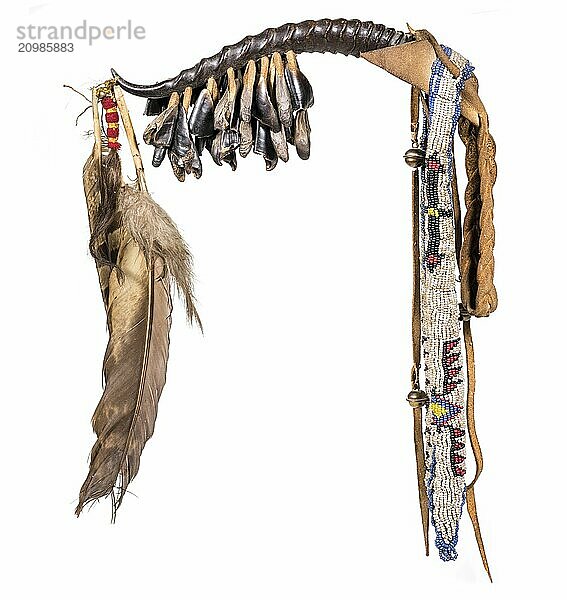 Dance rattle of the North American Indians made of horn with deer hooves and feathers cut out on white