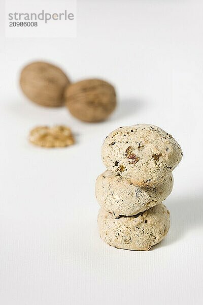 Cavallucci  typical Italian cookies with walnut and candied fruit on a white background