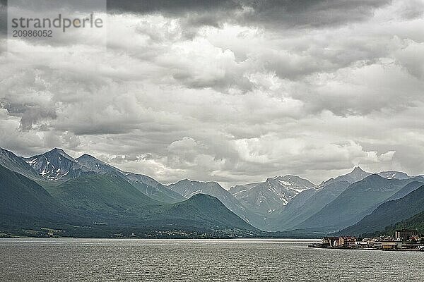 Andalsnes and mountains along the Romsdalsfjorden under a cloudy sky  Norway  Europe