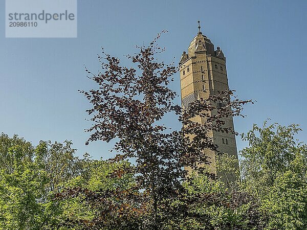 Historic tower rises above the treetops in quiet  green surroundings  trelleborg  sweden  baltic sea  scandinavia