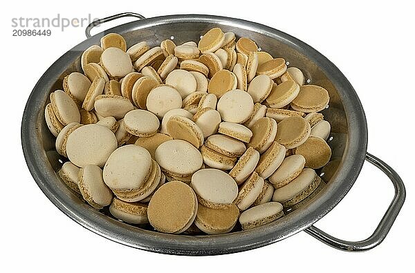 Home-baked aniseed Christmas biscuits in a metal bowl cropped on white