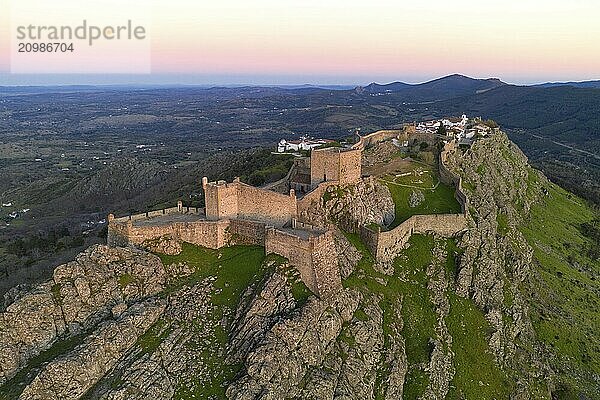 Marvao drone aerial view of the historic village and Serra de Sao Mamede mountain at sunset  in Portugal