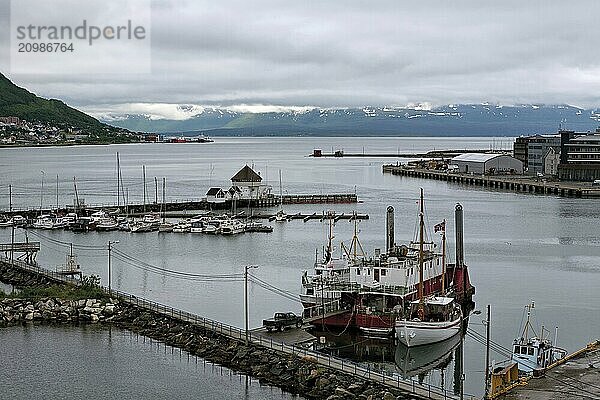 Harbour in Tromso and mountains on background in a cloudy day  Norway  Europe