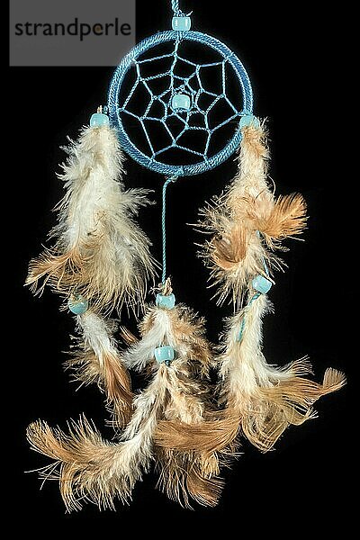 Beaded dreamcatcher with colourful feathers and beads against a black background