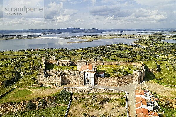 Mourao drone aerial view of castle with alqueva dam lake behind in Alentejo  Portugal  Europe