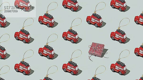 Gray green background pattern with Christmas  New Year symbol attribute objects and symbolic items concept. Small red English taxi car toy with ribbon  pink little gift box present.