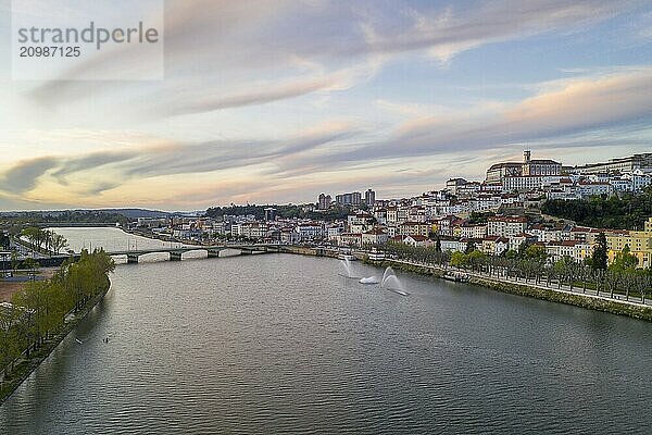 Coimbra drone aerial city view at sunset with Mondego river and beautiful historic buildings  in Portugal