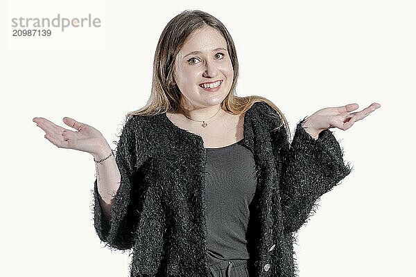 Girl with raised hands and black jacket looks forward with a smile