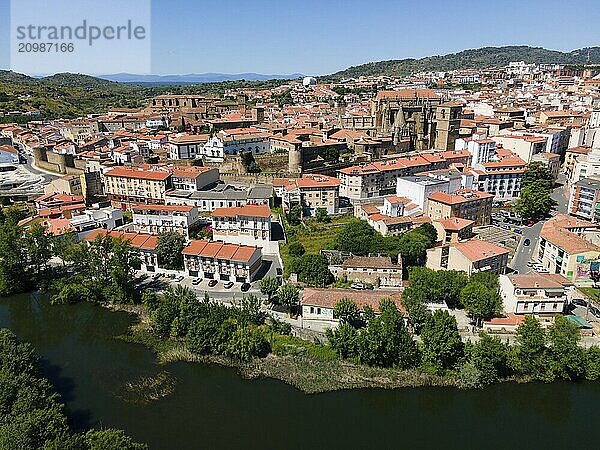 Historic city with red roofs and a dominant cathedral  surrounded by lush hills and a river in the foreground  aerial view  Plasencia  Jerte River  Cáceres  Caceres  Extremadura  Spain  Europe