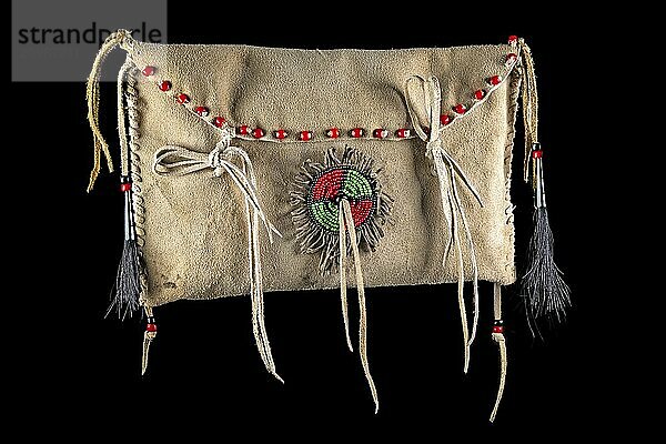 Bag of the North American Indians. Made from deerskin embroidered with colourful glass beads and leather cords on a black background