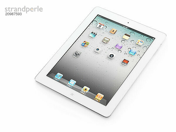 White Apple iPad 2 tablet computer with desktop icons on its display. Isolated with clipping path on white background