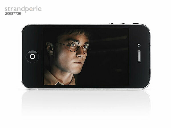 Harry Potter movie on display of Apple iPhone 4 smartphone isolated with clipping path on white background