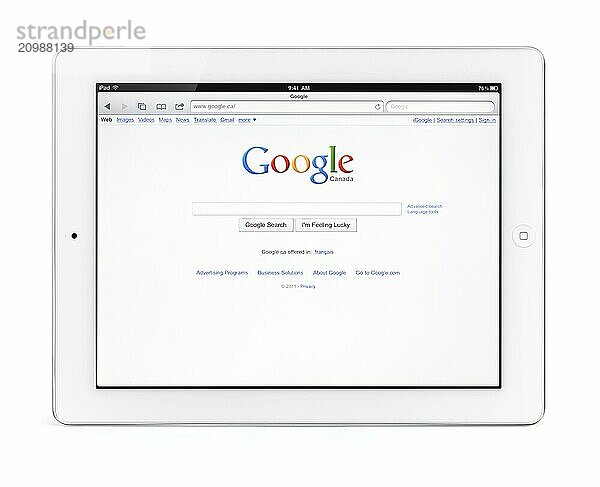 Apple iPad 2 tablet computer with Google search engine front page on its display. Isolated with clipping path on white background