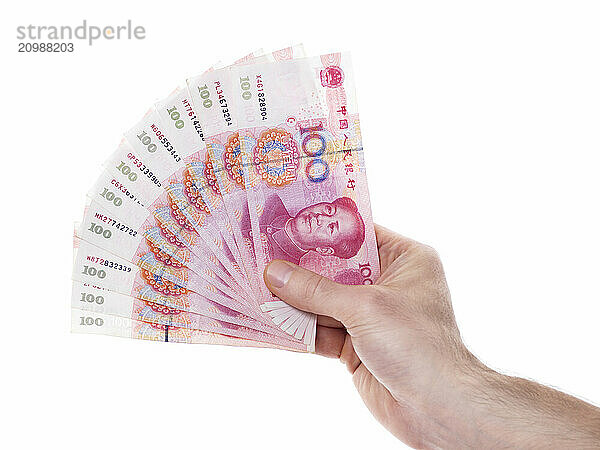 Male hand with Chinese Yuan 100 bills Renminbi money currency isolated on white background