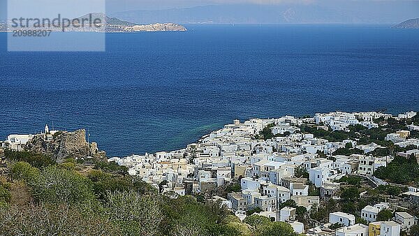 A coastal village of white houses stretches over a hill  offering sweeping views of the surrounding sea and distant islands  Morning light  Panagia Spiliani  Castle  Mandraki  Nisyros  Dodecanese  Greek Islands  Greece  Europe