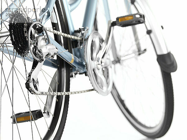 Detail closeup of a classic light blue womens bicycle isolated on white background