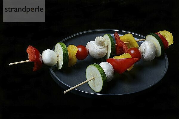 Colourful vegetable skewers on a plate  barbecue skewers