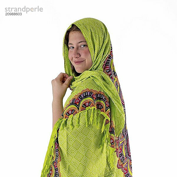 Smiling young girl with green headscarf looks into the camera cropped on white