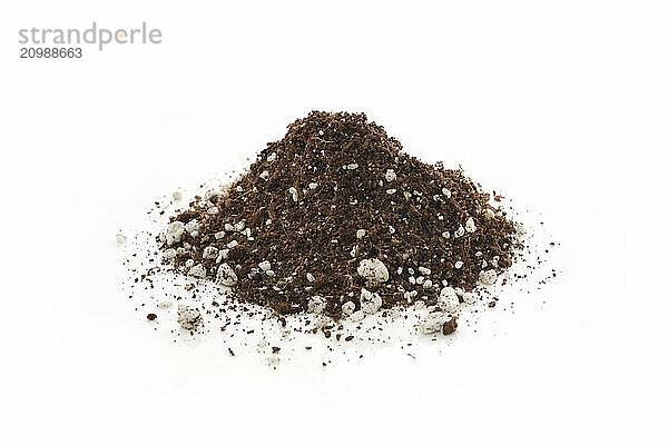 Germination media or soilless growing potting mix of coconut coir  vermiculite and perlite  used in horticulture and gardening instead of soil. Closeup of an isolated cone pile on white studio background