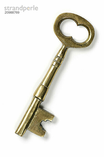 Old brass shiny skeleton keys isolated on white background