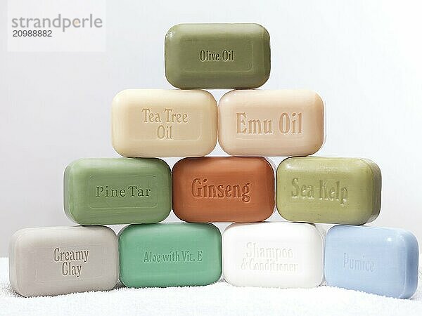 Several different soap bars with healthy natural ingredients on white background