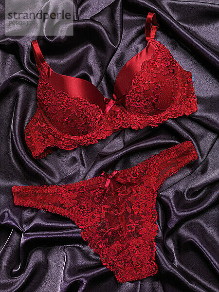 Red lacy lingerie womens underwear on black background