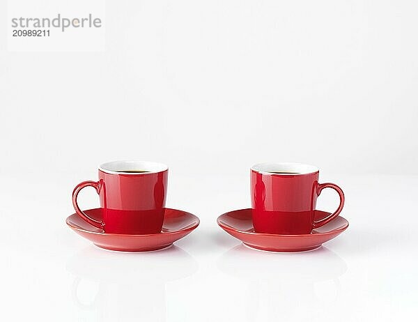 Two red small espresso coffee cups isolated on white background