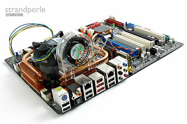 Computer motherboard with a CPU cooler and fan Isolated on white