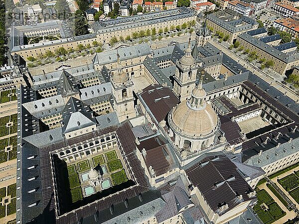 Historic monastery seen from the air  with a central courtyard and surrounded by the city  aerial view  Real Sitio de San Lorenzo de El Escorial  Royal Seat of St Lawrence of El Escorial  palace and monastery complex  San Lorenzo de El Escorial  Madrid  Spain  UNESCO World Heritage Site  Europe