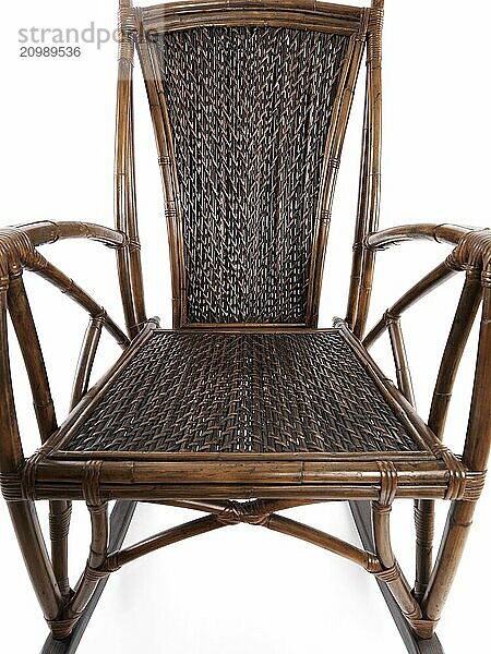 Abstract closeup of antique bamboo wicker rocking chair isolated on white background