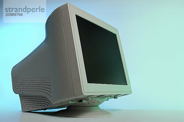 CRT computer monitor display side view close-up isolated on blue