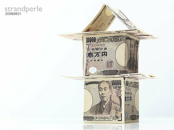 House made of Japanese Yen  money currency bills isolated on white background