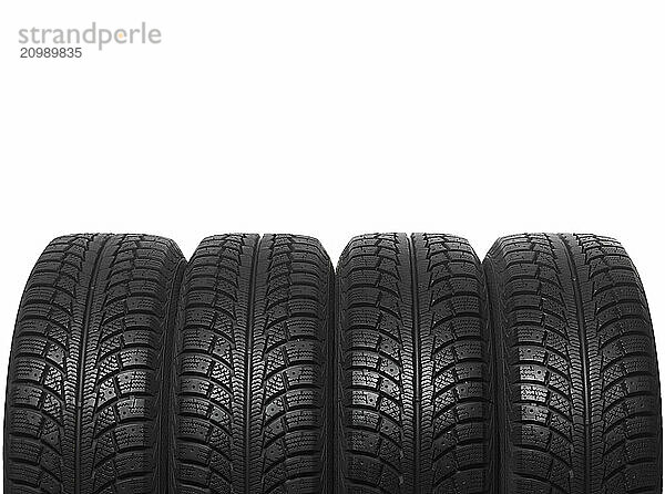 Set of four winter tires isolated on white background