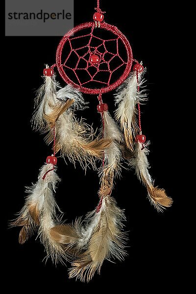 Beaded dreamcatcher with colourful feathers and beads against a black background