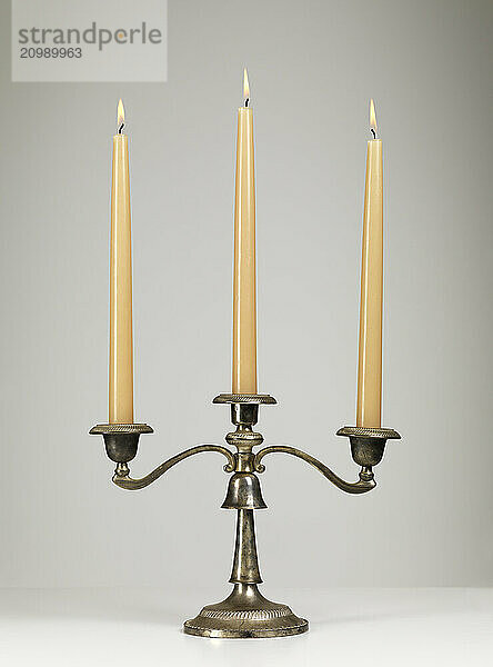 Antique silver triple candle holder candelabra isolated on gray background