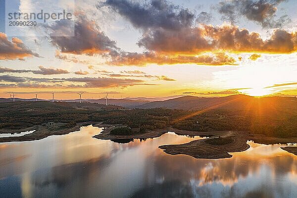 Drone aerial view of a lake reservoir of a dam with perfect reflection on the water of the sunset in Sabugal  Portugal  Europe