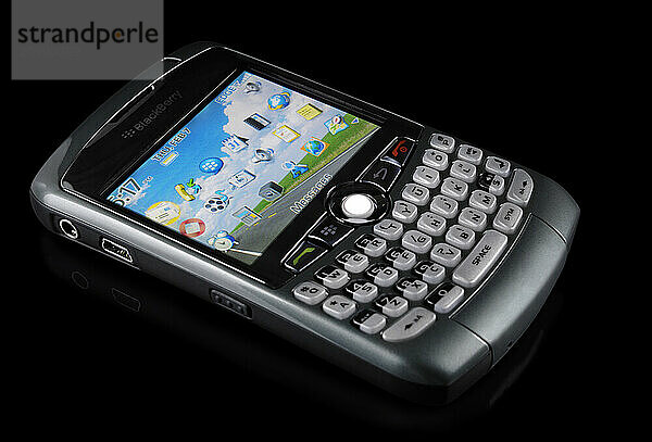 BlackBerry 8310 Curve stylish smartphone with illuminated display Isolated silhouette on black background with clipping path