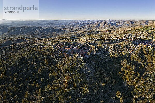 Drone aerial panorama of historic village of Sortelha with castle and with turbines on natural landscape  in Portugal