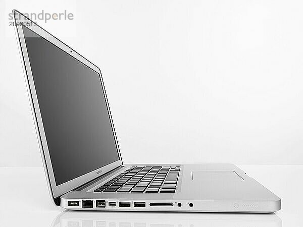 Apple Macbook Pro laptop computer side view isolated on white background