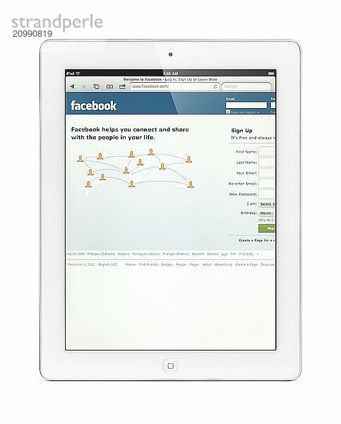 White Apple iPad 2 tablet computer with Facebook home page on its display. Isolated with clipping path on white background