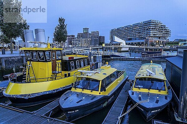 Mooring of the water taxi  behind it the former Fenix warehouse from 1923  destroyed in the war  renovated in 2019  converted into a residential and commercial building  with hotel  flats  restaurants  offices  on the Rijnhaven  Rijnhavenbrug  bridge  Rotterdam  Netherlands