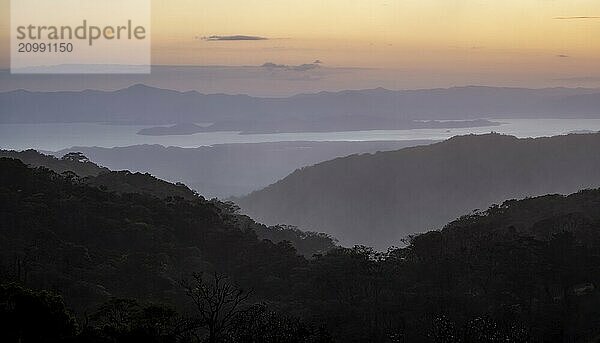 View to the sea over wooded hills  at sunset  cloud forest  Monte Verde  Puntarenas province  Costa Rica  Central America