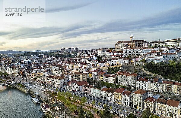 Coimbra drone aerial city view at sunset with Mondego river and beautiful historic buildings  in Portugal