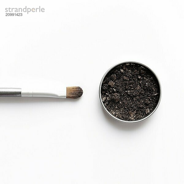 Dark brown face shadow in container and eye shadow or make-up brush. Makeup concept flat lay on white background