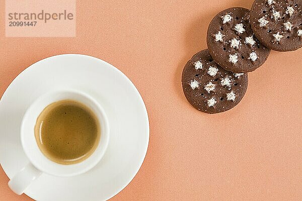 Italian coffee and biscuits on pink background seen from above