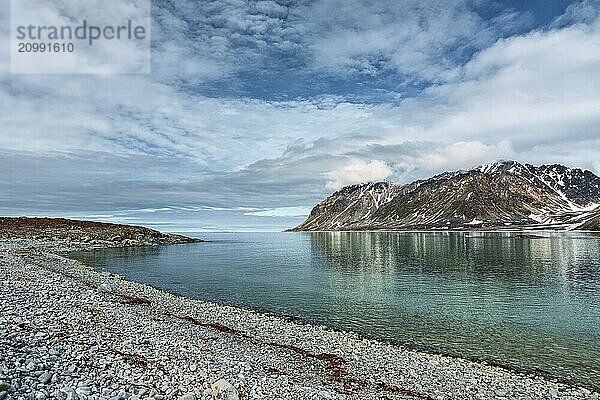 Cloudy sky and mountains along the bank in Magdalenafjord in Svalbard islands  Norway  Europe