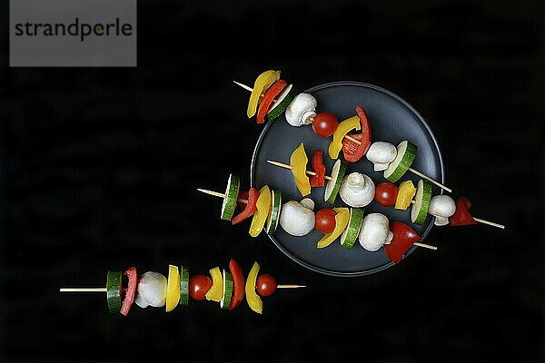 Colourful vegetable skewers on a plate  barbecue skewers